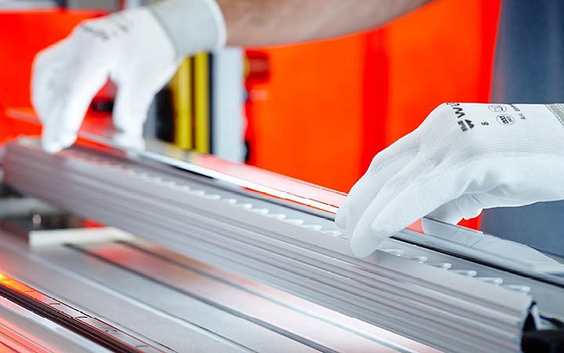 Our meticulous assembly process ensures precision as the protective glass is carefully positioned onto the LED luminaire, finalizing a high-quality lighting solution.